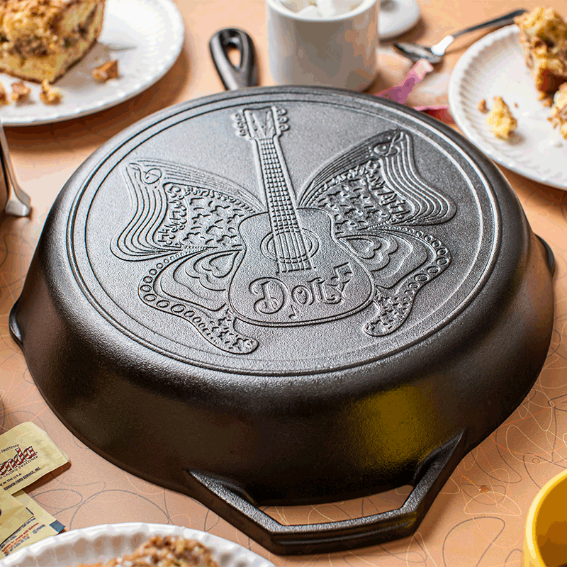 Handcrafted cast iron skillet with embossed butterfly and guitar design featuring "Dolly" lettering, made in USA, ideal for Kitchen & Food, Cookware, Cast Iron, Best Sellers, and Promo Eligible collections.