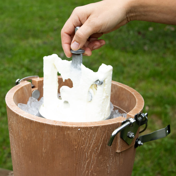 Close-up of a hand lifting the central churn dasher from a handcrafted wooden ice cream freezer filled with ice, showcasing a traditional Amish-made design in Kitchen & Food and Specialty Equipment collections.