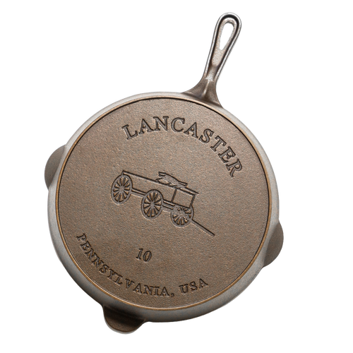 Bottom view of a handcrafted Lancaster cast iron skillet with embossed horse-drawn wagon design, size 10, made in USA, ideal for Kitchen & Food, Cast Iron, Camping, and Farm collections