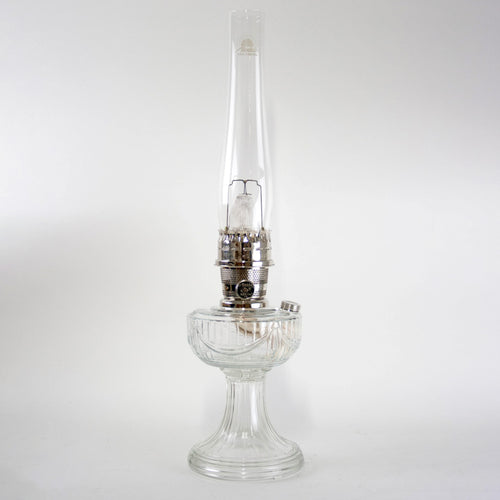 Handcrafted clear glass oil lamp with a unique Lincoln Drape pattern base and polished metal burner, made in USA, featured in Lamps & Lighting, Oil Lamps, Table Lamps, Best Sellers, Promo Eligible collections.