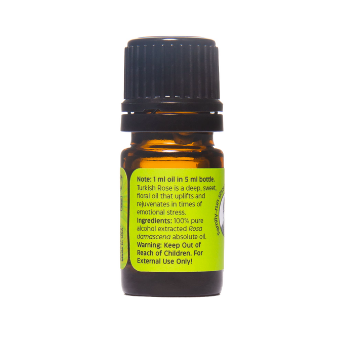 Small amber glass bottle with black cap containing 100% pure Turkish Rose absolute oil, featuring a bright green label with usage and ingredient details, part of Health & Wellness and USA Made collections.