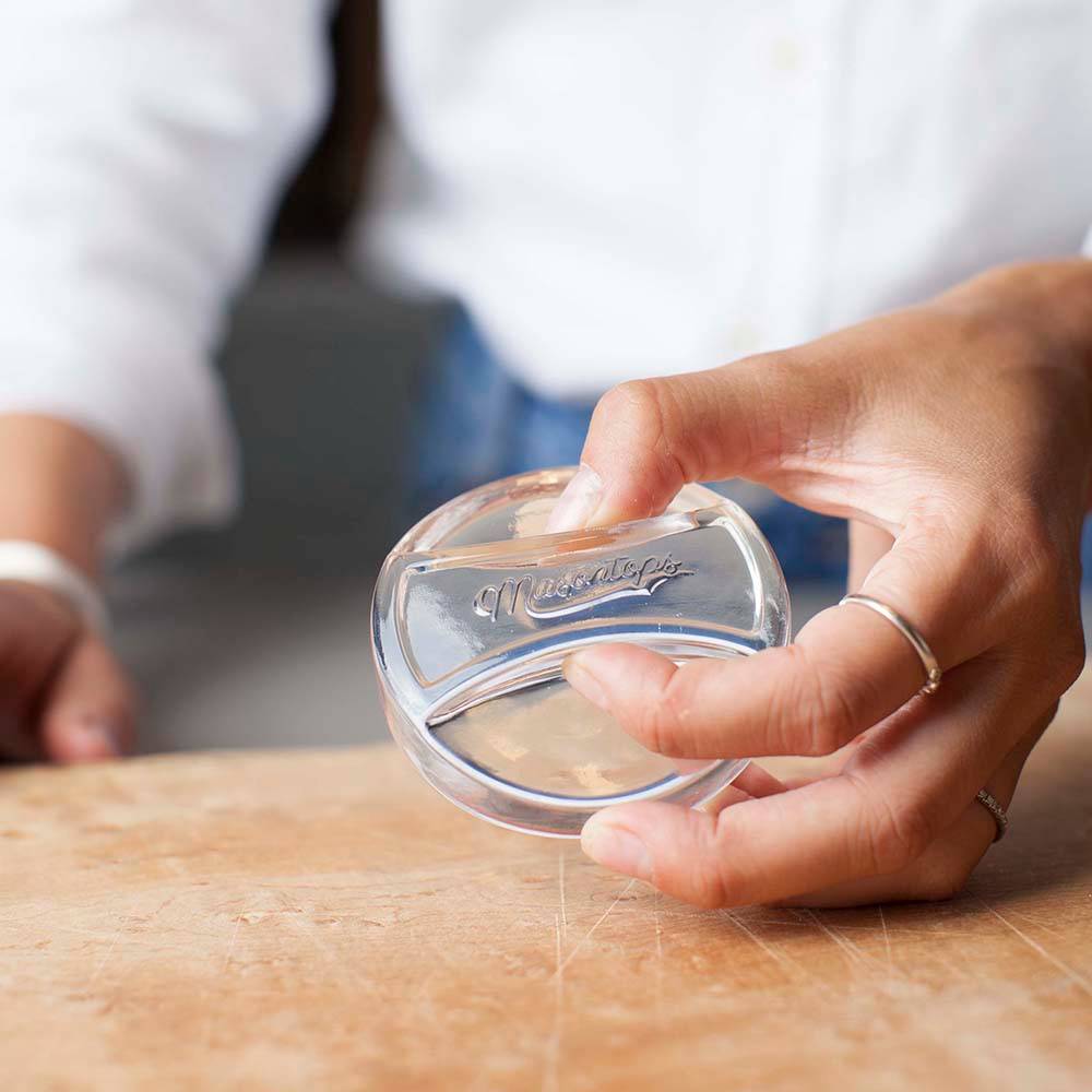 Clear, handmade glass fermentation weight held by hand, crafted to keep food submerged in jars, ideal for Kitchen & Food, Food Preservation, Fermenting and Pickling, and Best Sellers collections.