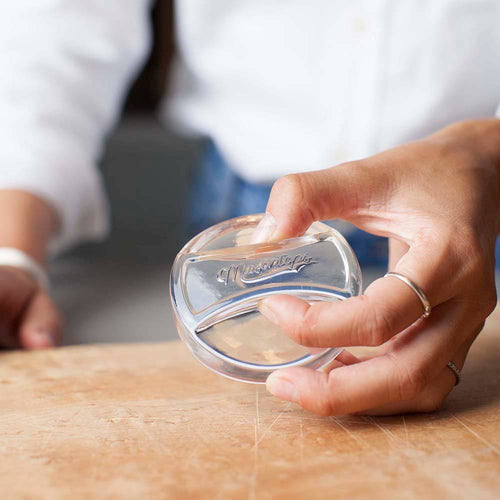 Clear, handmade glass fermentation weight held by hand, crafted to keep food submerged in jars, ideal for Kitchen & Food, Food Preservation, Fermenting and Pickling, and Best Sellers collections.