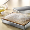 Rectangular baking pan made in USA with recycled steel and a unique corrugated surface, shown with a fresh baked cake, ideal for Kitchen & Food, Cookware, Baking Supplies, and Best Sellers collections.