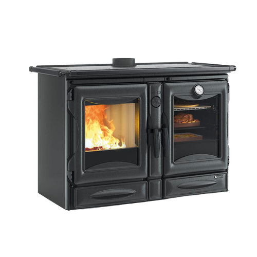 Black enameled cast iron wood stove with visible fire through left door and cooking oven with food and thermometer on right, part of Stoves and Cookstoves collections.