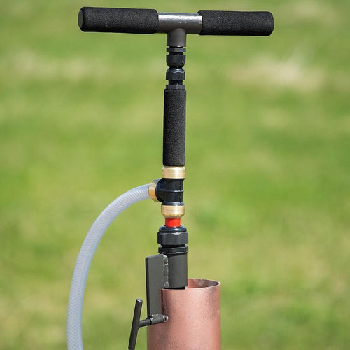 Slim hand pump with foam grip handles attached to well casing, designed for quick water access during power outages, featured in farm, garden, and emergency supply collections.