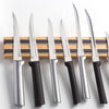 Handcrafted heavy duty hardwood magnetic knife rack holding an assortment of kitchen knives with metal and black handles, ideal for kitchen, food prep, and tool organization.