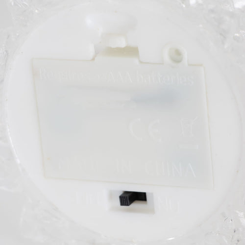Close-up view of the battery compartment and on/off switch on a clear acrylic Christmas tree base, designed for indoor holiday decor in Home & Decor and Holiday collections.