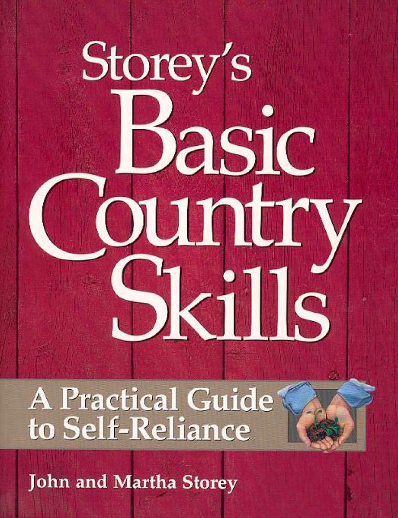 Close-up of a book cover titled Basic Country Skills with a rustic red wood background, featuring a practical guide to self-reliance and an image of hands holding seedlings, suitable for heritage and lifestyle, farm and livestock, and home and garden collections.