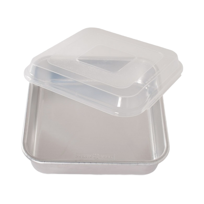 Square aluminum cake pan with encapsulated galvanized steel rims to prevent warping and a clear plastic lid for convenient storage, ideal for baking in Kitchen & Food collections.