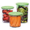 Set of three reusable vacuum seal containers with green lids, holding fresh strawberries, carrot sticks, and mixed leafy greens, designed for kitchen food preservation and storage.
