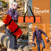 Man carrying a bright orange CarryOX gear bag through a wooded area with logs and chainsaw nearby, featured in Farm, Garden & Tool, Wood Cutting and Hauling, USA Made, Best Sellers, and Promo Eligible collections.