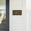 Black and gold rectangular custom address plaque with bold numbers mounted on white siding near a dark door, handcrafted in USA for Home & Decor, Household Helpers, and Mailboxes and Address Signs collections.