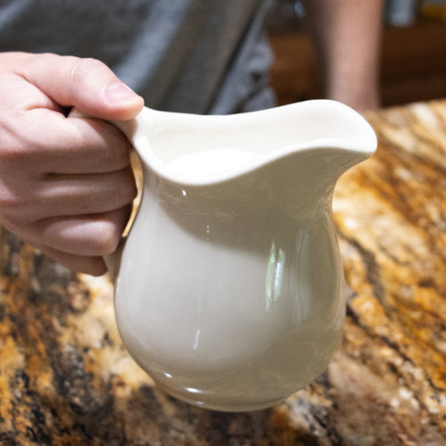 Handcrafted white stoneware pitcher with a classic design, made in USA and microwave safe, ideal for serving beverages in Kitchen & Food, Dinnerware, and Storage collections.