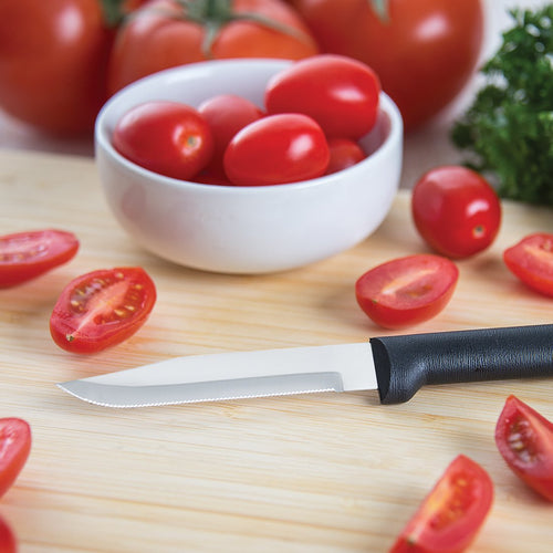 Handcrafted serrated paring knife with a super-fine stainless steel blade and smooth black handle, made in USA, surrounded by sliced and whole tomatoes on a wooden cutting board, ideal for Farm, Garden & Tool and Kitchen & Food collections.