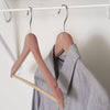Set of two handcrafted cedar hangers with contoured notched shoulders and fixed horizontal bars, naturally freshening and protecting clothes in Health & Wellness and Home & Decor collections.