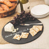Round handcrafted slate board serving crackers, grapes, and gorgonzola cheese labeled with soapstone chalk, ideal for Kitchen & Food, Storage and Serving, Best Sellers, and Promo Eligible collections.