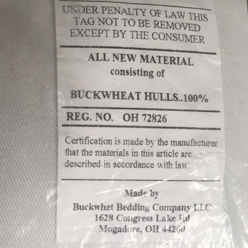 Close-up of a certification label detailing 100% buckwheat hull filling inside a handcrafted pillow, made in the USA, part of Home & Decor, Home Textiles, USA Made, and Best Sellers collections.