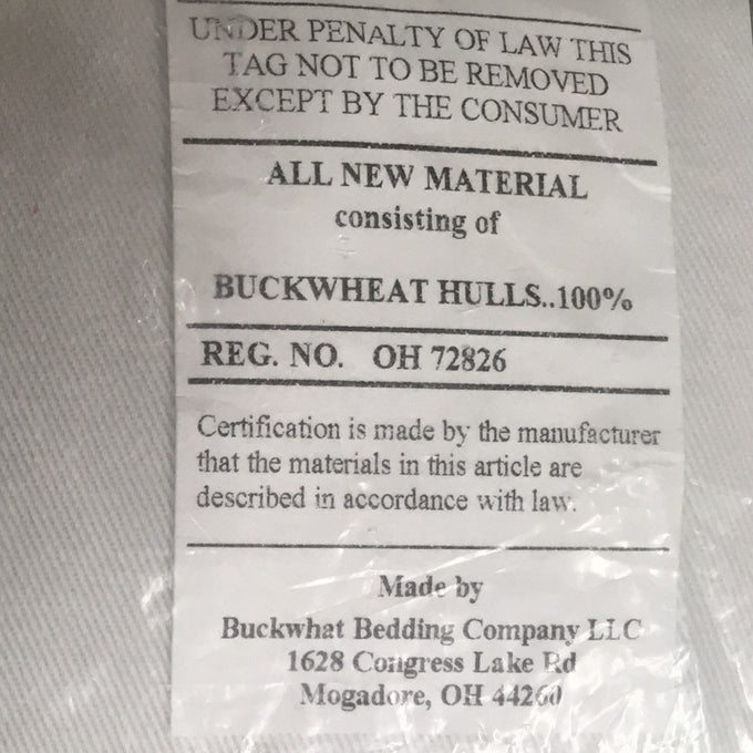 Close-up of a certification label detailing 100% buckwheat hull filling inside a handcrafted pillow, made in the USA, part of Home & Decor, Home Textiles, USA Made, and Best Sellers collections.