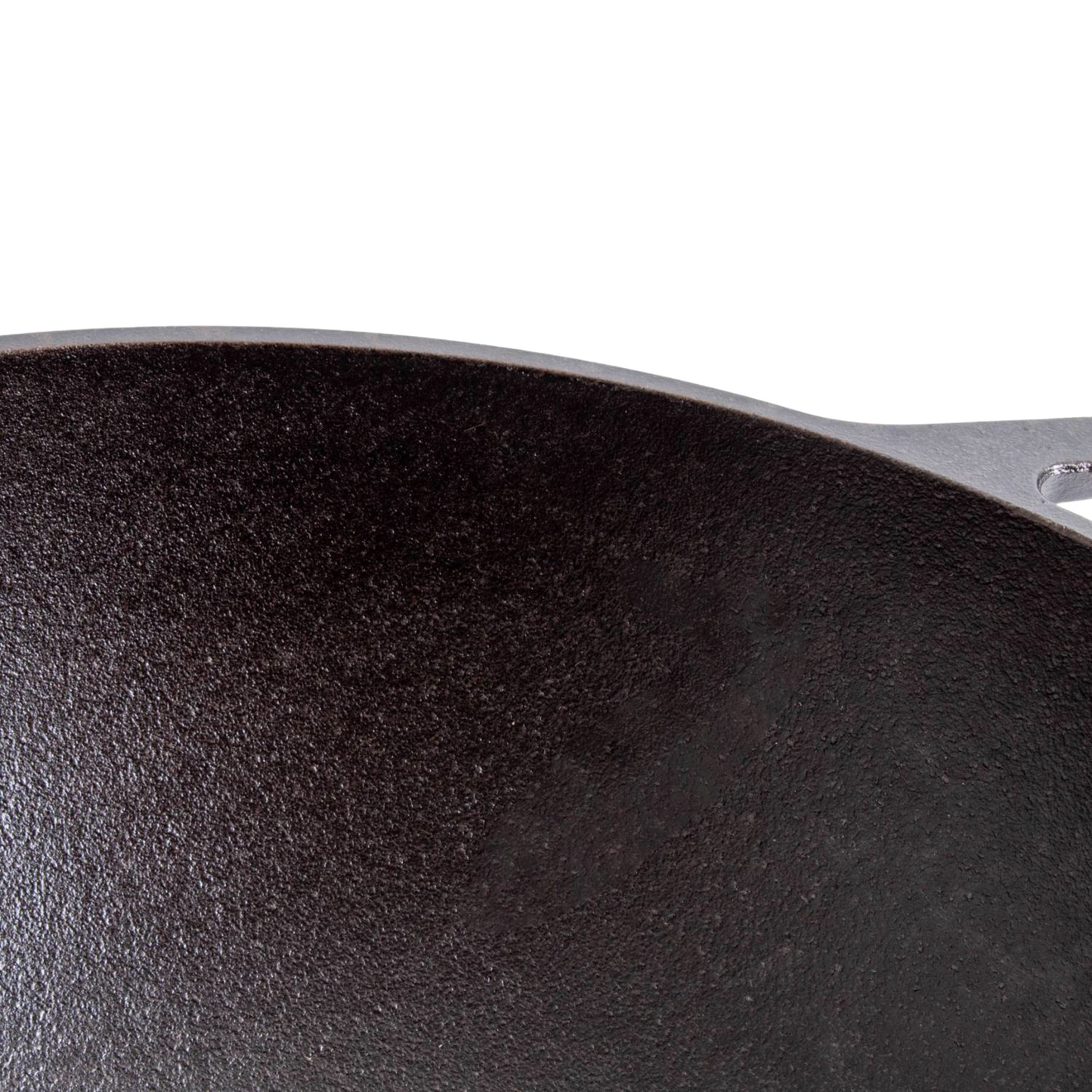Close-up of a seasoned cast iron cookware surface with a wide base, highlighting durable construction and excellent heat retention, ideal for Kitchen & Food, Cookware, Cast Iron, USA Made, and Best Sellers collections.