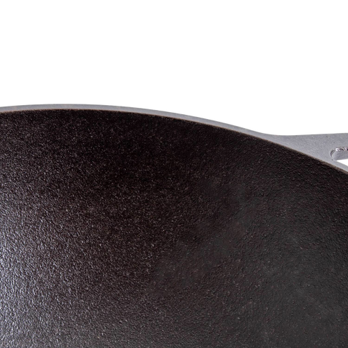 Close-up of a seasoned cast iron cookware surface with a wide base, highlighting durable construction and excellent heat retention, ideal for Kitchen & Food, Cookware, Cast Iron, USA Made, and Best Sellers collections.