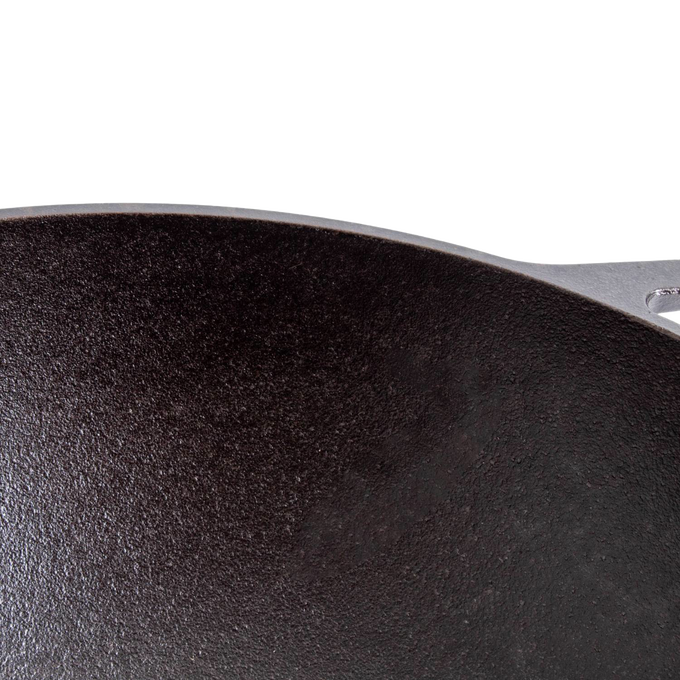 Close-up of a seasoned cast iron cookware surface with a wide base, highlighting durable construction and excellent heat retention, ideal for Kitchen & Food, Cookware, Cast Iron, USA Made, and Best Sellers collections.