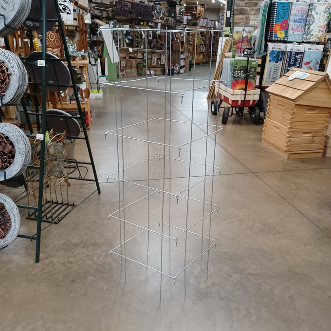 Handcrafted square collapsible steel tomato cage with durable 9-gauge galvanized wire, made in USA, shown in a store aisle with gardening and home decor products nearby, featured in Farm, Garden & Tool, Seeds and Planting, USA Made, Best Sellers, and Promo Eligible collections.