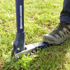Gardener using a mechanical weed puller with rust-resistant stainless steel claws and long nylon fiberglass handle to remove weeds from green lawn, featured in Farm, Garden & Tool and Lawncare collections.