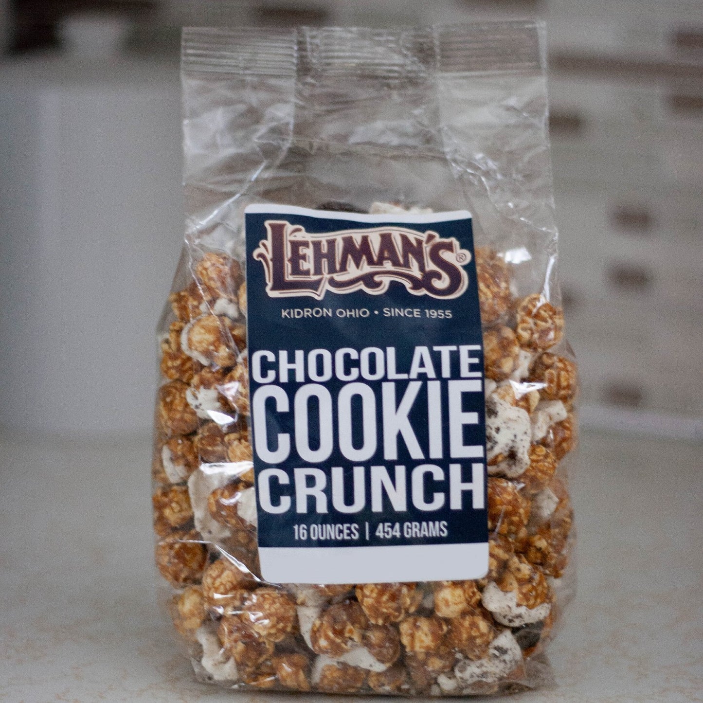 Clear bag of handcrafted caramel popcorn blended with rich chocolate cookie crunch pieces, a unique sweet and crunchy treat made in USA, ideal for Kitchen & Food, Snacks and Sweets, Popcorn, USA Made, Best Sellers, and Promo Eligible collections.