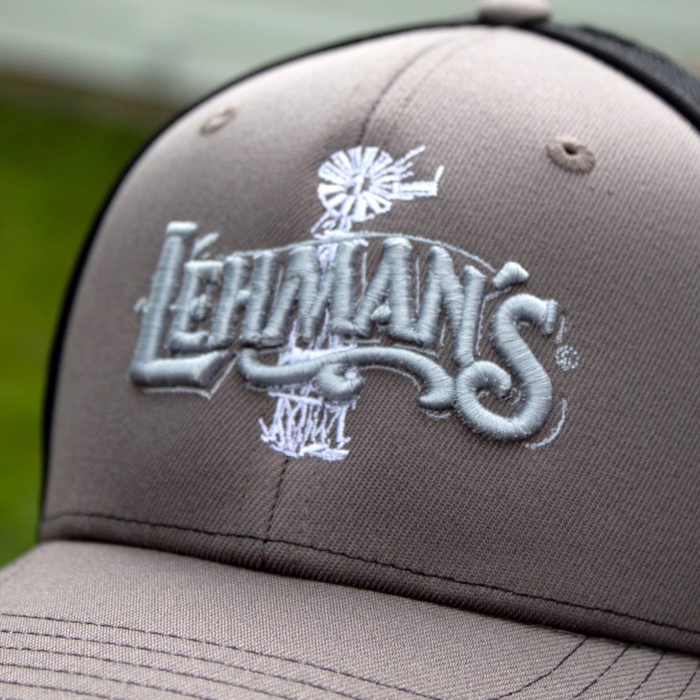 Close-up of a handcrafted embroidered trucker hat with a breathable stretch mesh back, featuring a detailed front logo design, perfect for Health & Wellness, Clothing and Accessories, Best Sellers, and Promo Eligible collections.