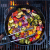 Handcrafted cast iron grilling basket with dual handles, filled with grilled colorful vegetables including broccoli, red and yellow peppers, and onions, cooking over open flame, ideal for Kitchen & Food, Cookware, Cast Iron, Grilling, and Best Sellers collections.