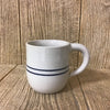 Handcrafted stoneware mug with a round shape and blue stripe design, made in the USA, ideal for coffee or tea, featured in Kitchen & Food and Brewing Coffee and Tea collections.