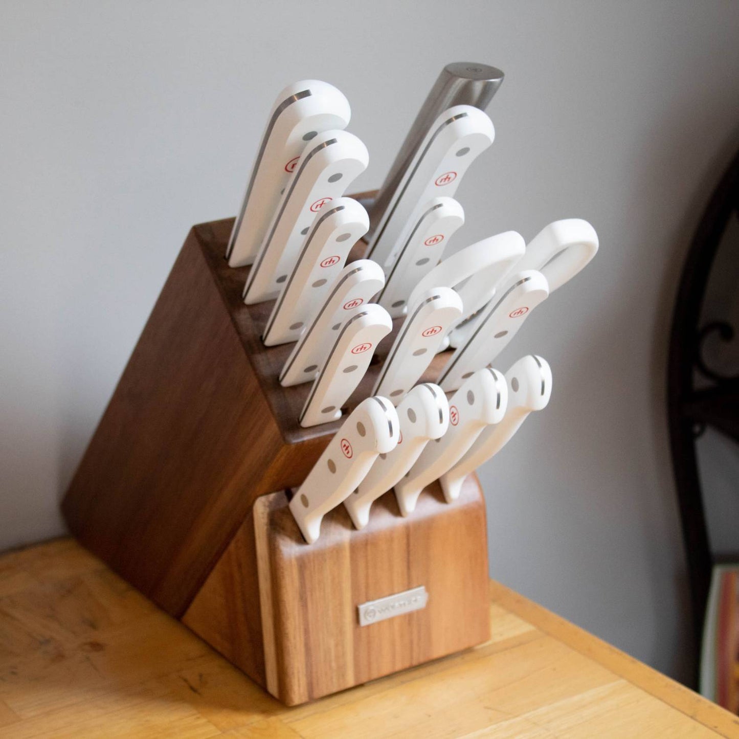16-piece Wusthof Gourmet knife set with white ergonomic handles and stainless steel blades, displayed in a wooden block for organized storage, ideal for Kitchen & Food and Food Prep collections.