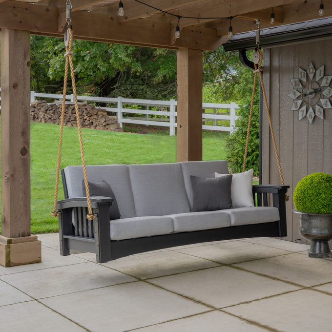 Handcrafted Mission Sofa 7 ft rope swing with thick gray cushions hanging under a wooden porch, set in a green backyard, featured in Home & Decor, Outdoor Furniture, USA Made, Amish Made collections.