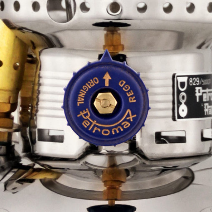 Close-up of the bright blue control valve on a polished metal kerosene pressure lamp showcasing precise craftsmanship and durable construction for outdoor, camping, and emergency lighting use.