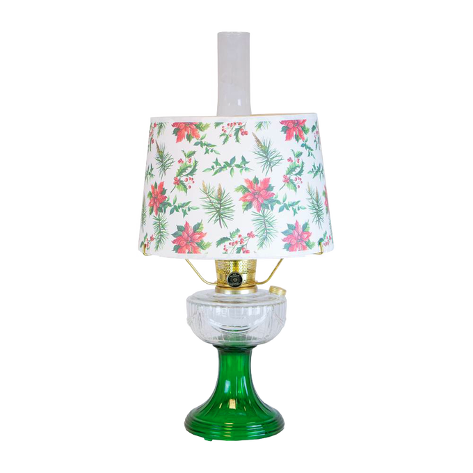 Handcrafted oil lamp with clear over emerald glass base and festive holly and pine patterned lampshade, featured in Lamps & Lighting, Oil Lamps, Table Lamps, and Best Sellers collections.