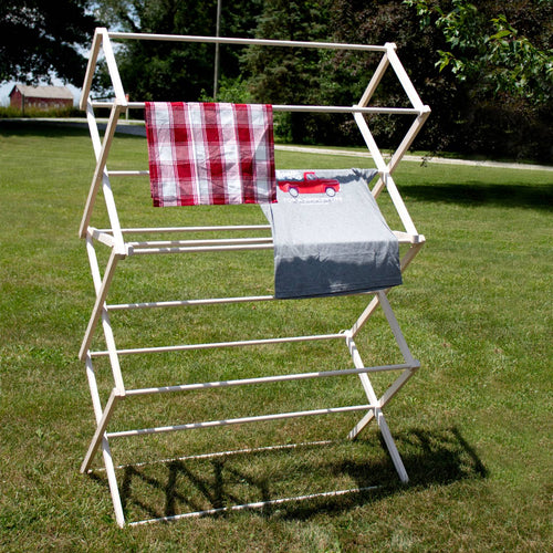 Large handcrafted wooden clothes drying rack with multiple tiers holding laundry outdoors on green grass, showcasing Amish made quality for Home & Decor and Laundry Supplies collections.