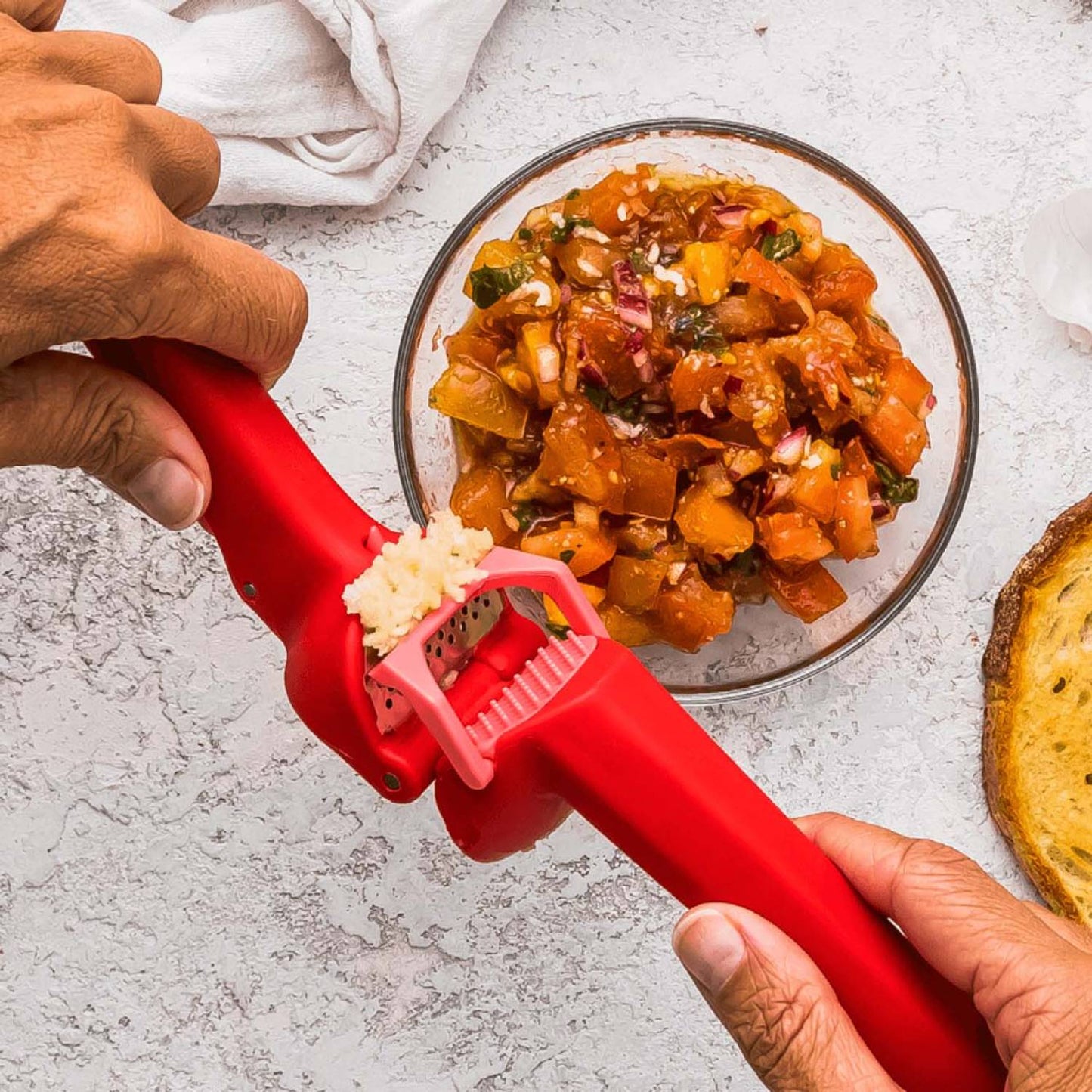 Red Garject Lite Garlic Press efficiently mincing garlic cloves while self-scraping and ejecting peels, perfect for Kitchen & Food, Food Prep, Choppers and Cutters, Kitchen Gadgets, and Cooking and Baking Helpers collections.