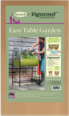 Woman tending to plants in a green raised fabric planter with a clear polyethylene greenhouse cover and black metal frame, designed for easy self-watering in Farm, Garden & Tool and Garden Accessories collections.