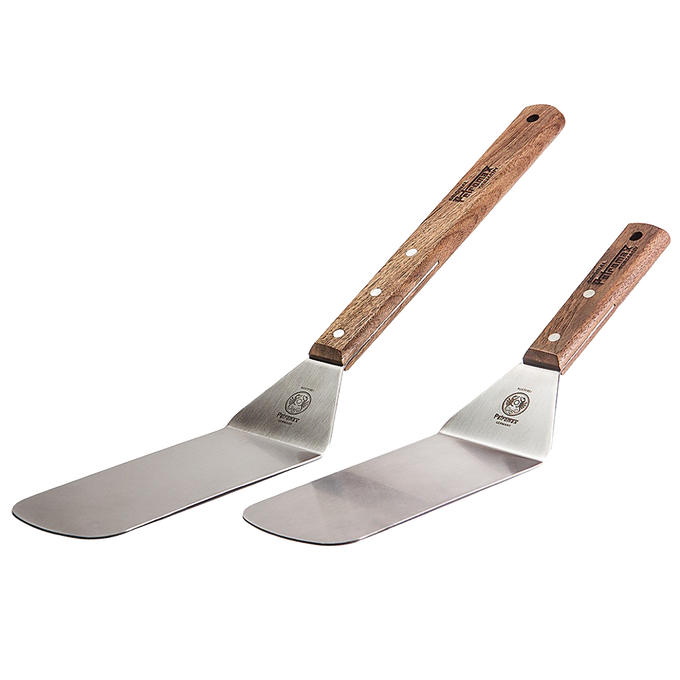 Two flexible spatulas with broad polished stainless steel blades and sturdy wooden handles with visible rivets, designed for grilling and kitchen tasks in Kitchen & Food, Stoves, and Cooking Helpers collections.