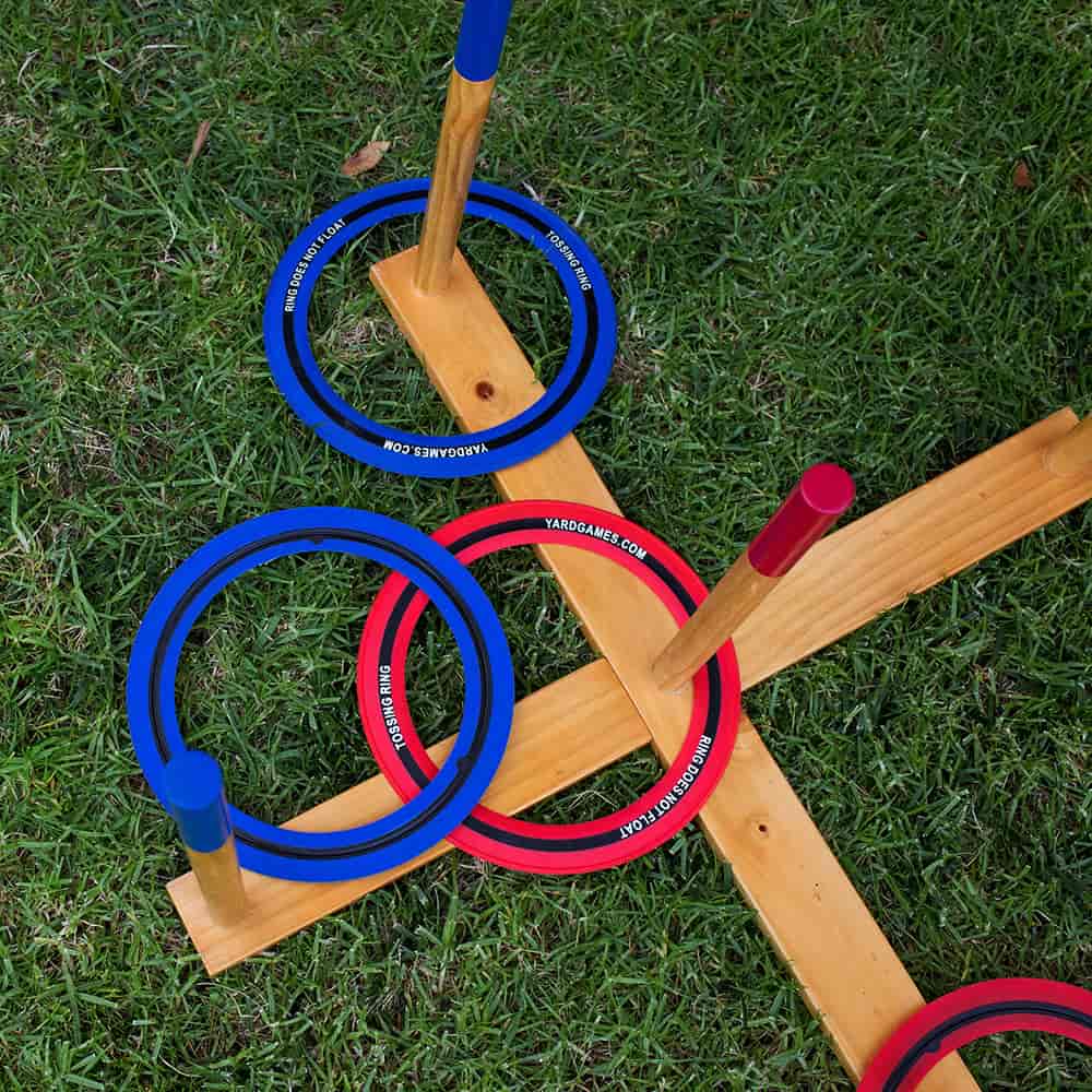 Wooden lawn game set with large blue and red tossing rings placed on pegs attached to a natural wood cross frame, suitable for outdoor play in Toys, Books & Games and Lawn Games collections.