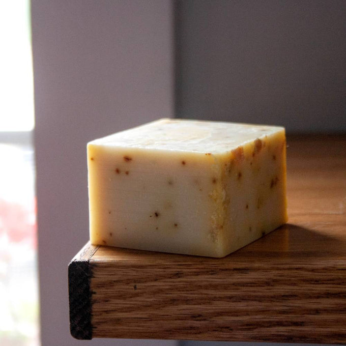 Handcrafted hypoallergenic bar soap with a creamy off-white color and natural specks, made in USA, ideal for Health & Wellness, Grooming, and Soaps collections.