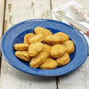 Blue enamelware plate filled with golden brown freeze-dried chicken nuggets on a rustic wooden table, highlighting a long-lasting food option from Kitchen & Food and USA Made collections.