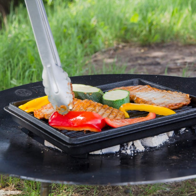 Square cast iron griddle pan grilling colorful bell peppers, zucchini slices, and seasoned meat over outdoor coals, perfect for Farm, Garden & Tool, Kitchen & Food, Camping, and Cookware collections.