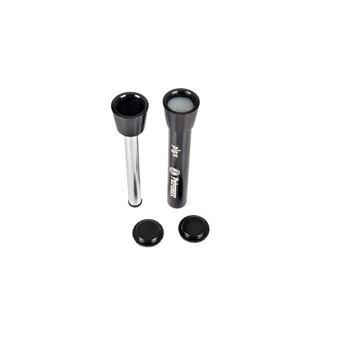 Two compact fire starting plungers with black tops and caps, one filled with tinder, designed for reliable use in camping, emergency supplies, and farm tool collections.