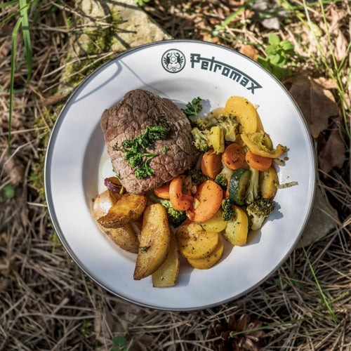 Sturdy white enamel plate with black rim and Petromax logo, holding grilled steak and seasoned mixed vegetables, perfect for camping, kitchen, and outdoor dining in Farm, Garden & Tool, Dinnerware, Best Sellers, and Promo Eligible collections.