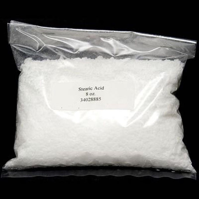 Clear resealable plastic bag containing 8 ounces of white stearic acid flakes used to strengthen and improve quality in candle making, featured in candles and soapmaking supplies.