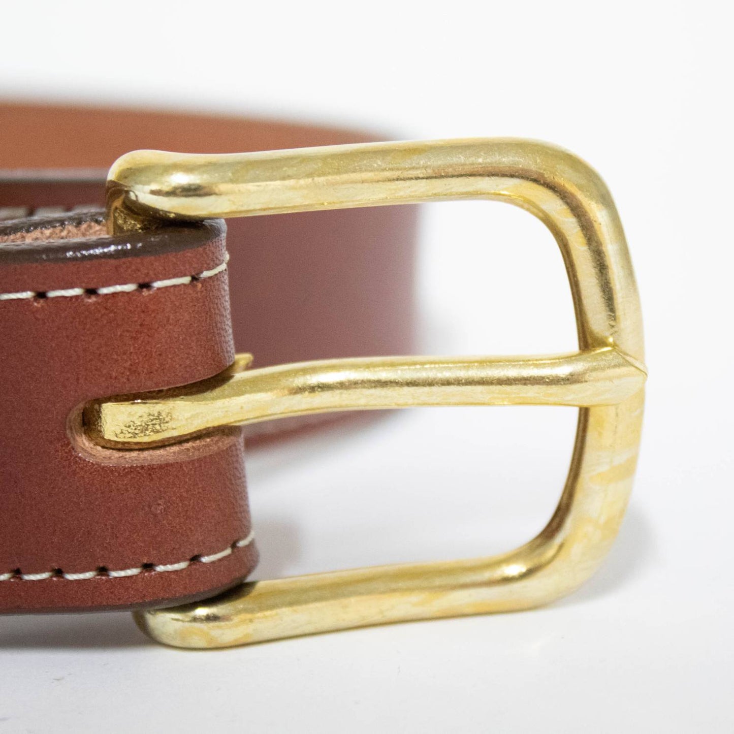 Close-up of a handcrafted Amish-made rich brown leather belt with precise stitching and a polished solid brass buckle, featured in Clothing and Accessories, USA Made, Amish Made collections.