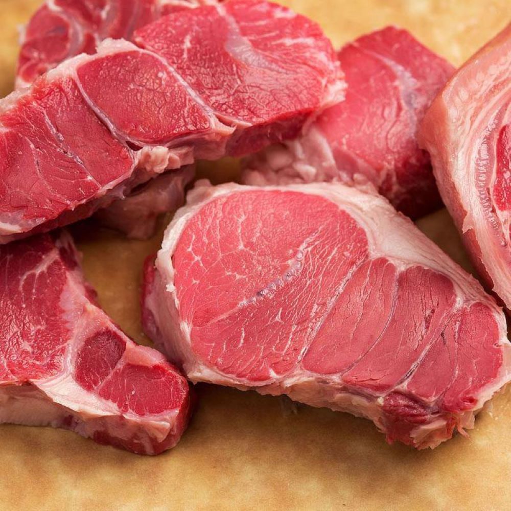 Close-up of raw cured pork hocks showcasing marbled red meat and fat, highlighting handcrafted quality for use in Kitchen & Food, Pantry, and USA Made collections.