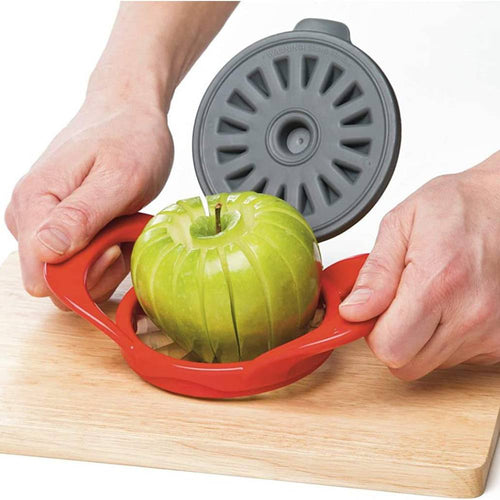 Red hard plastic apple slicer with stainless steel blades cutting a green apple into thin uniform wedges, featuring a removable gray protective cover, ideal for kitchen and baking helpers.